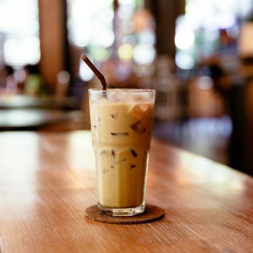 glass-of-iced-coffee-on-the-table-in-a-coffee-shop-royalty-free-image-1643751238